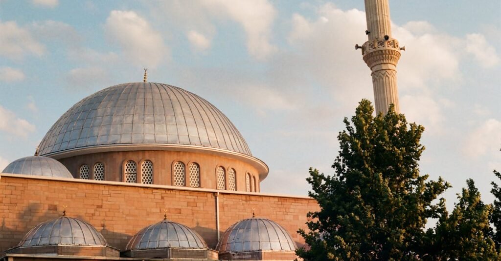 Captivating view of Yanus Emre Mosque with its iconic dome and minaret in Karaman, Turkey during sunset.