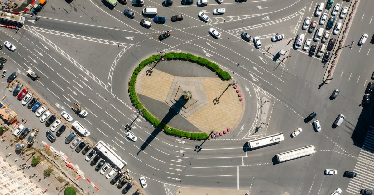 High-angle aerial view of a busy urban intersection with a central roundabout.