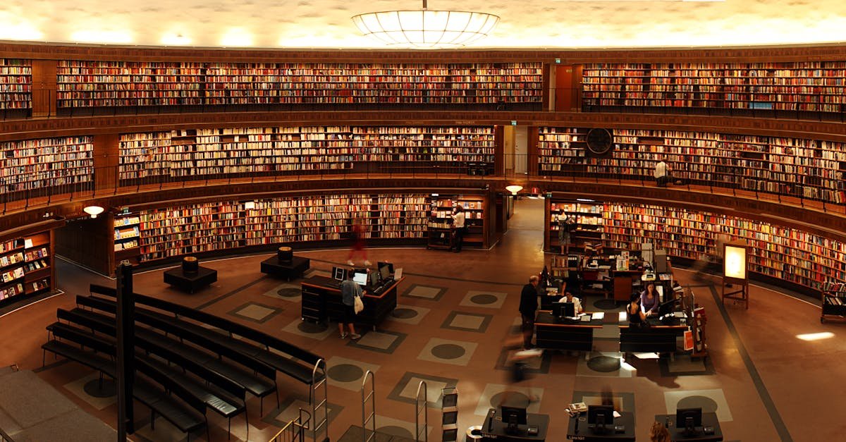 Panoramic view of a grand circular library with shelves full of books and study desks.