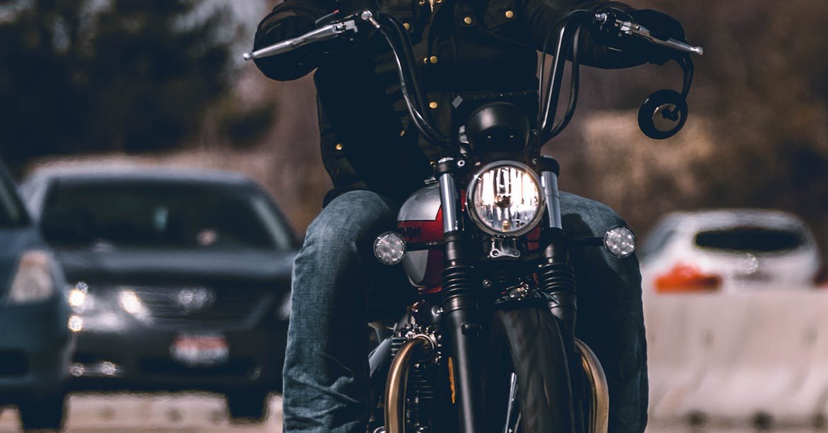 Bearded man riding a motorcycle on a busy urban highway, showcasing speed and style.