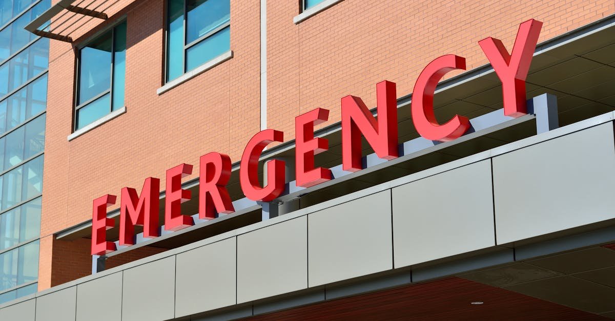 Close-up of a modern hospital emergency room entrance with prominent red letters.