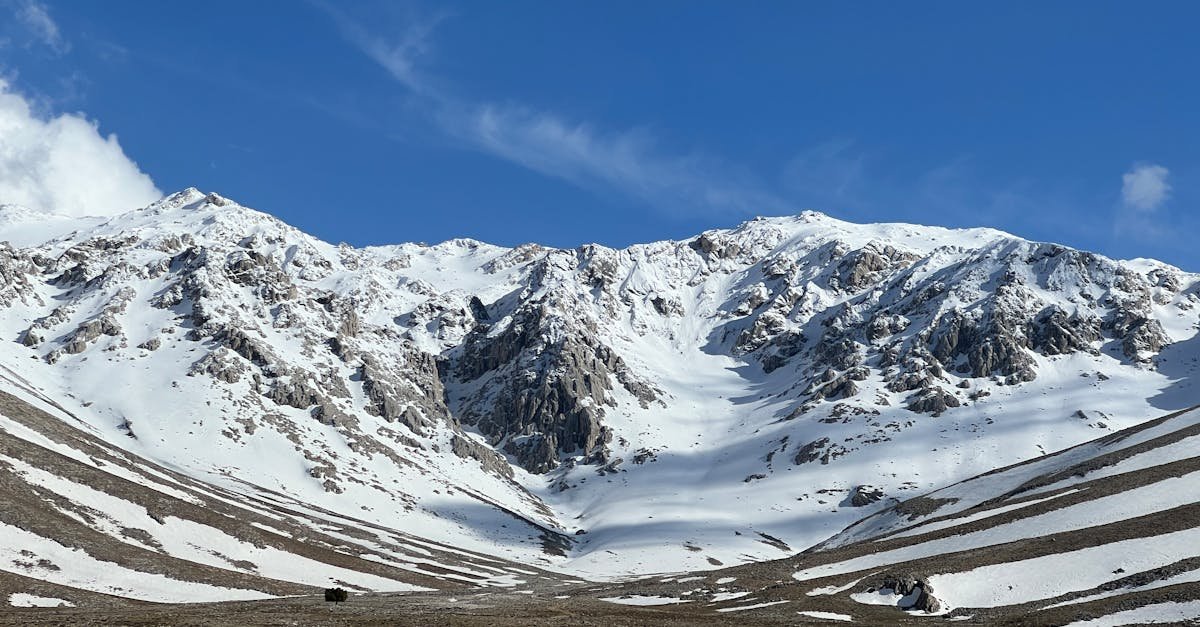 Breathtaking view of snow-covered mountains under a clear blue sky.