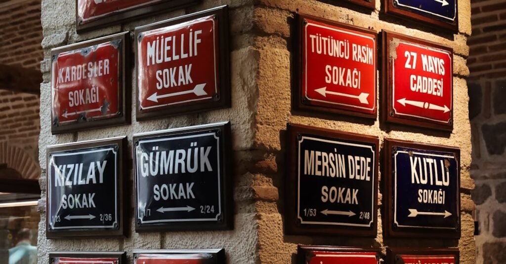 Decorative Turkish street signs on stone wall in Ankara with vibrant colors.