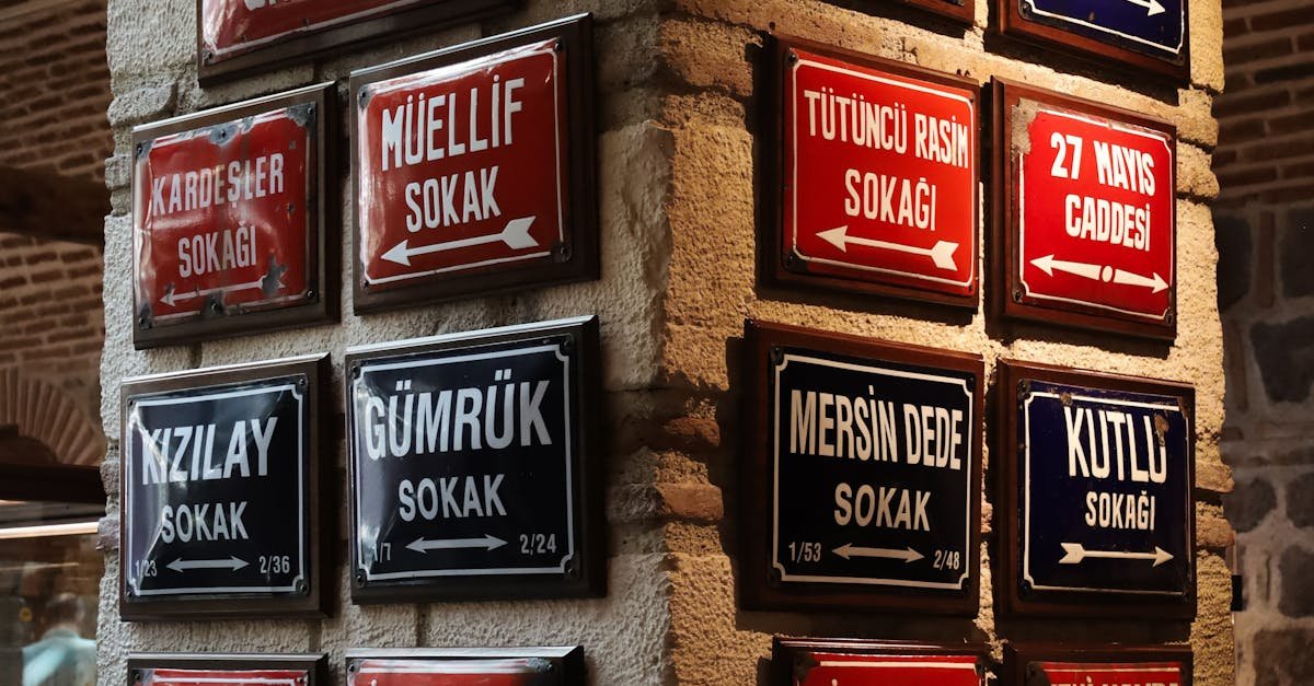 Decorative Turkish street signs on stone wall in Ankara with vibrant colors.