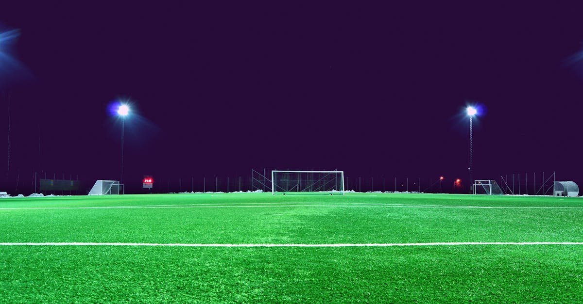 A brightly lit soccer field at night in Norrtälje, Sweden, showcasing green turf and stadium lights.
