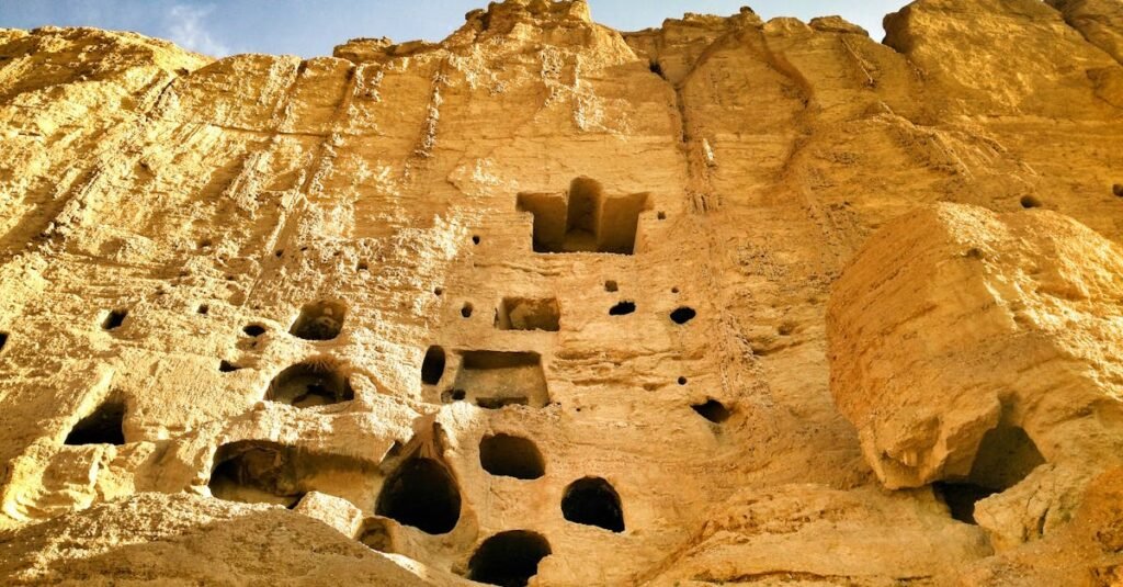 Low angle view of ancient cliff dwellings carved in Bamyan, Afghanistan.