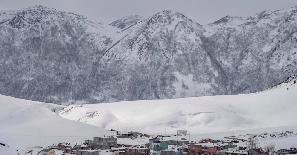 A scenic view of a snow-covered village in the mountains of Bitlis, Türkiye.
