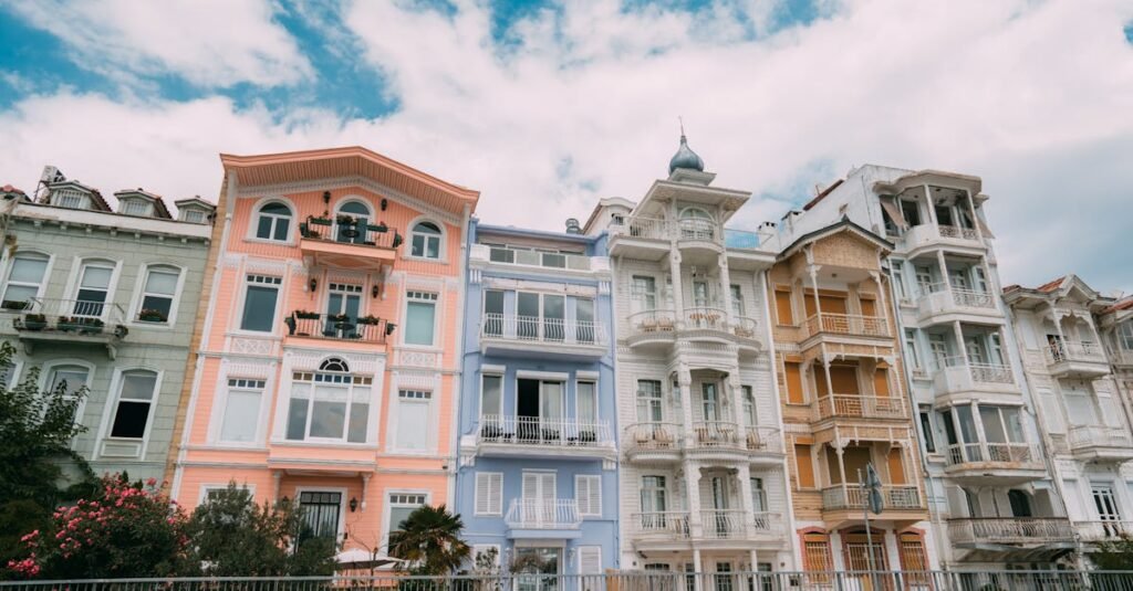 Vibrant historical buildings in Arnavutköy, Istanbul against a blue sky.