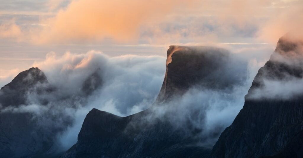 Ethereal sunrise over misty Norwegian mountains, capturing serene beauty and magical light.