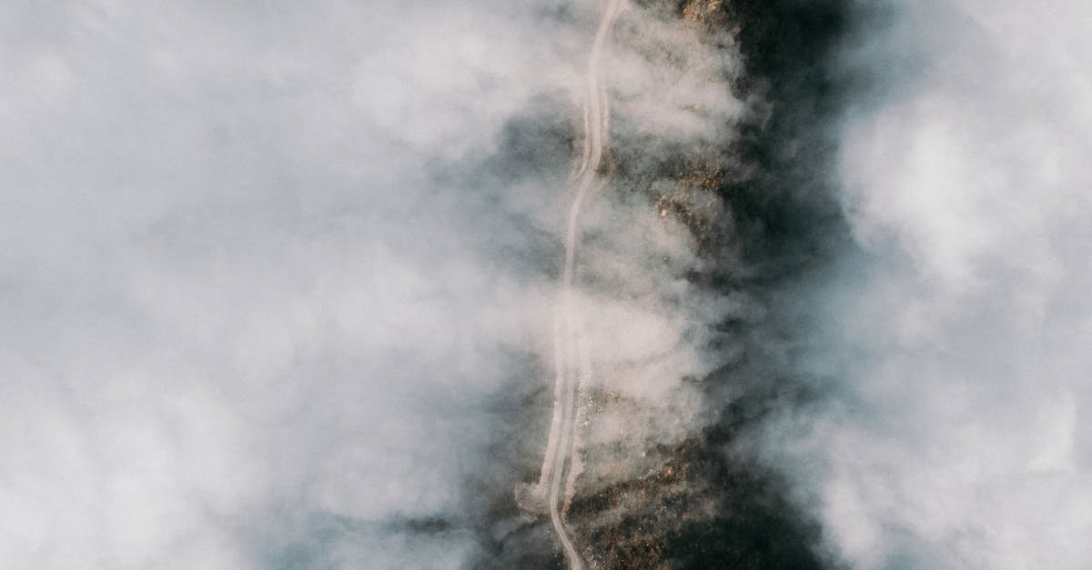 A mysterious aerial photograph capturing a winding road through dense fog in Artvin, Türkiye.
