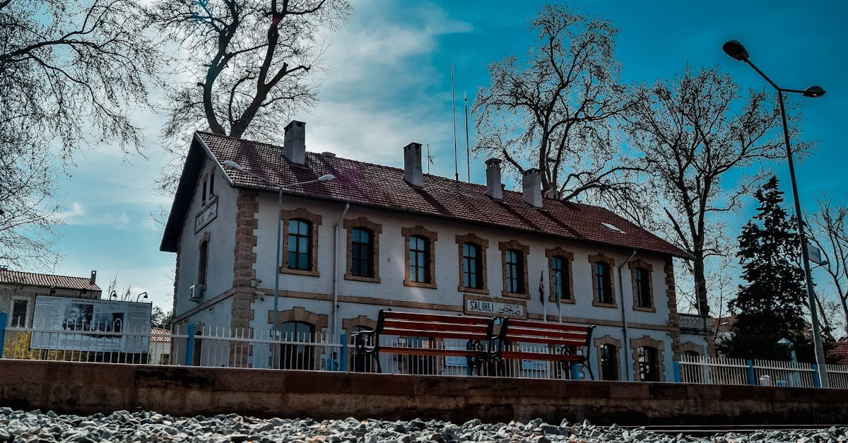 A scenic view of a historic train station in Manisa, Turkey, showcasing architectural charm.