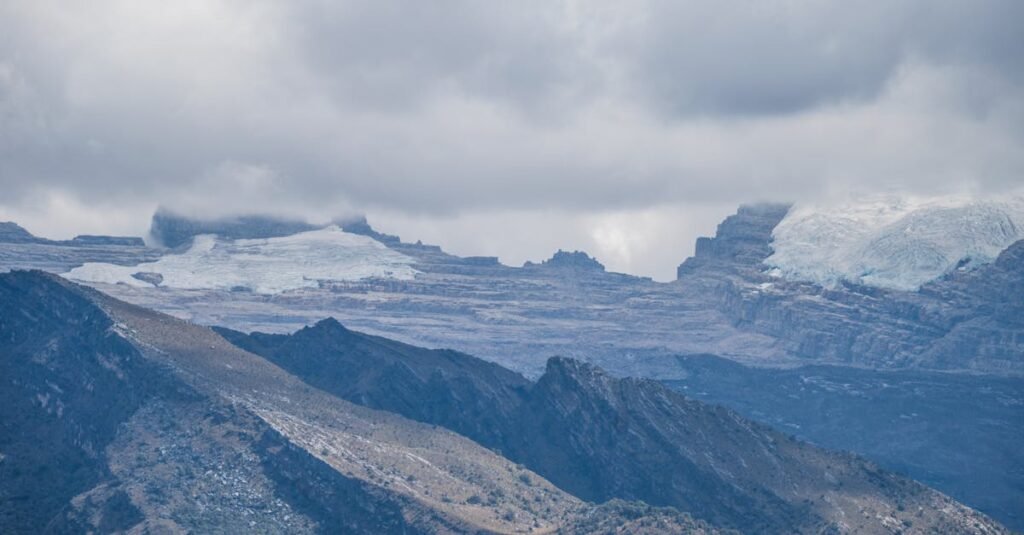 Breathtaking view of the Andes Mountains with glaciers and cloudy sky in El Cocuy National Park, Colombia.
