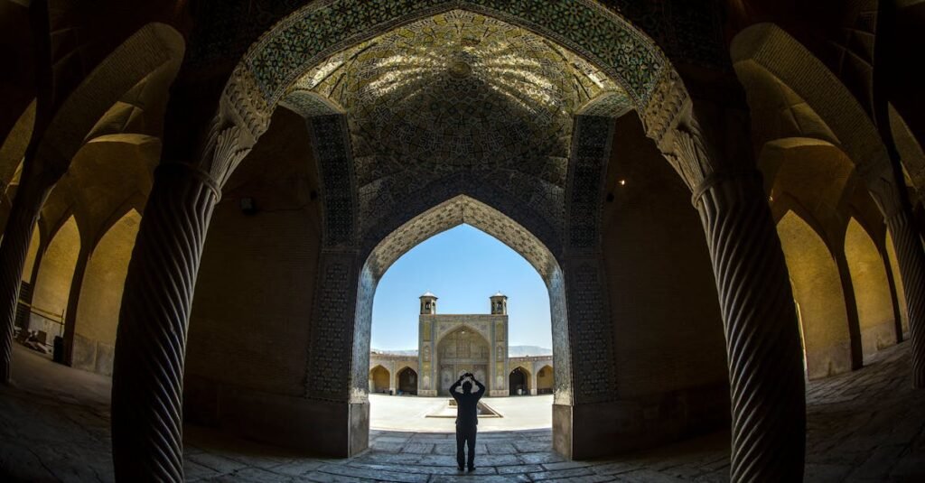 Explore the stunning arches and intricate details of the historic Vakil Mosque in Shiraz, Iran.