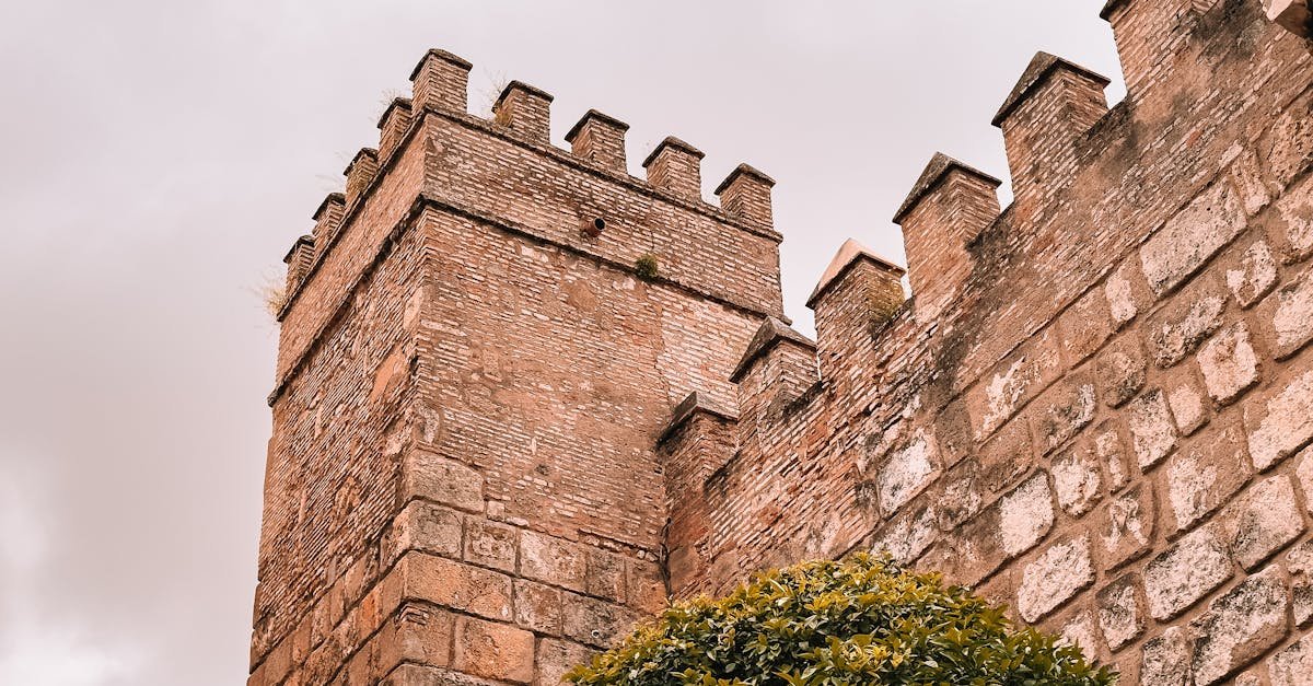 A detailed view of the historic Moorish fortress wall in Seville, Spain, showcasing traditional architectural design.