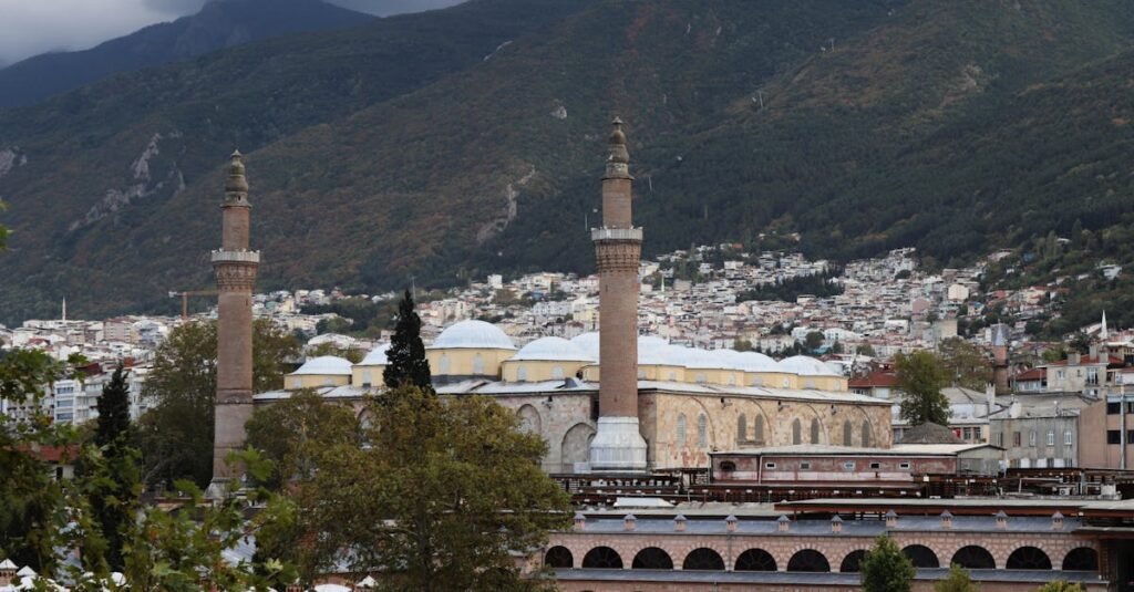 Beautiful view of Bursa's Grand Mosque with a mountain backdrop, capturing the city's historic architecture.