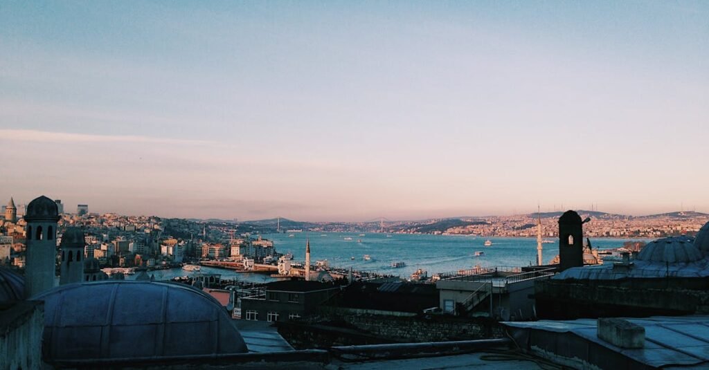 Capture of Istanbul cityscape with the Bosphorus, showcasing historic architecture and bustling waterways at sunset.