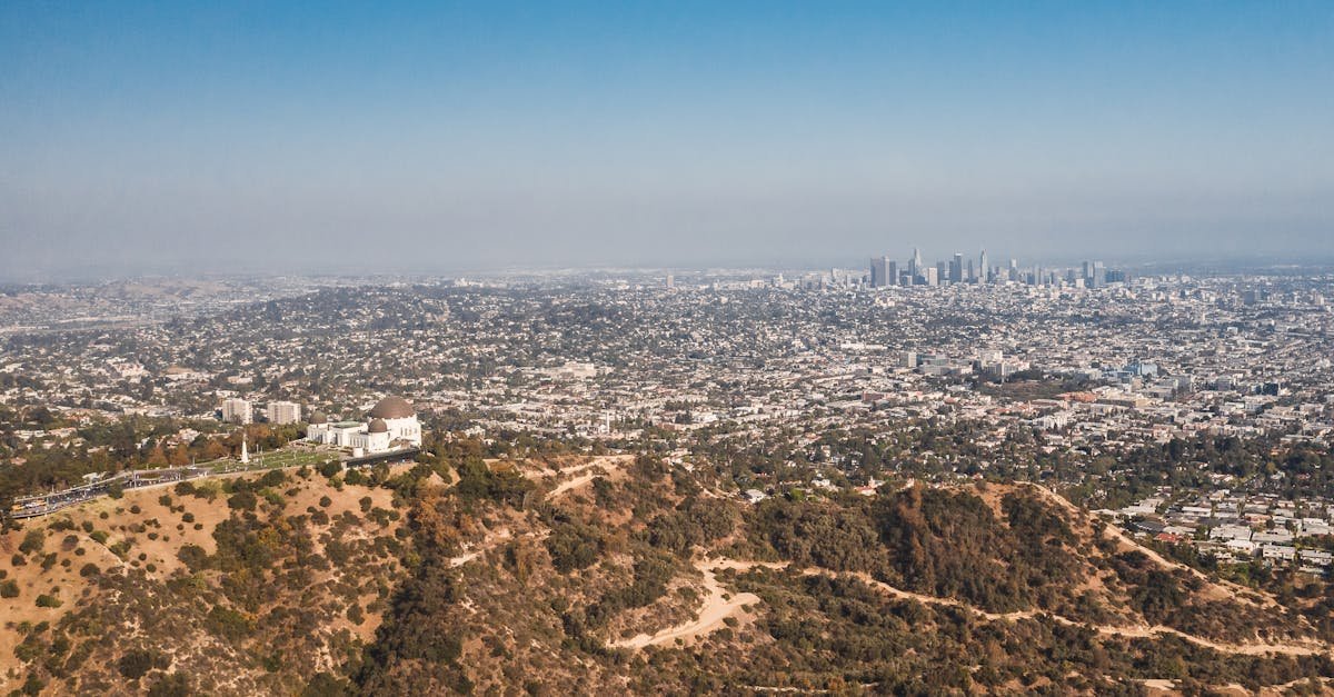 Stunning aerial view of Los Angeles with Griffith Observatory in the foreground on a clear day.