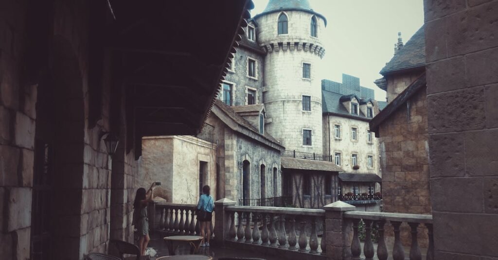 Explore a historic castle courtyard with stunning stone architecture and towering structures.