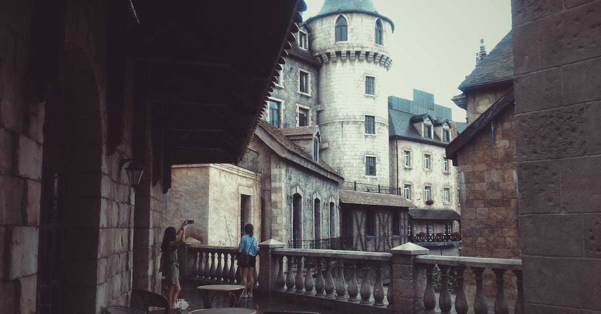 Explore a historic castle courtyard with stunning stone architecture and towering structures.