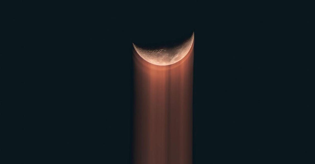 Artistic depiction of a crescent moon with trailing light streaks against a dark night sky.