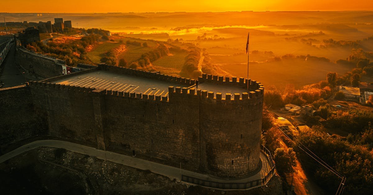 Stunning aerial view of historic Diyarbakır Fortress illuminated by sunrise in Türkiye.