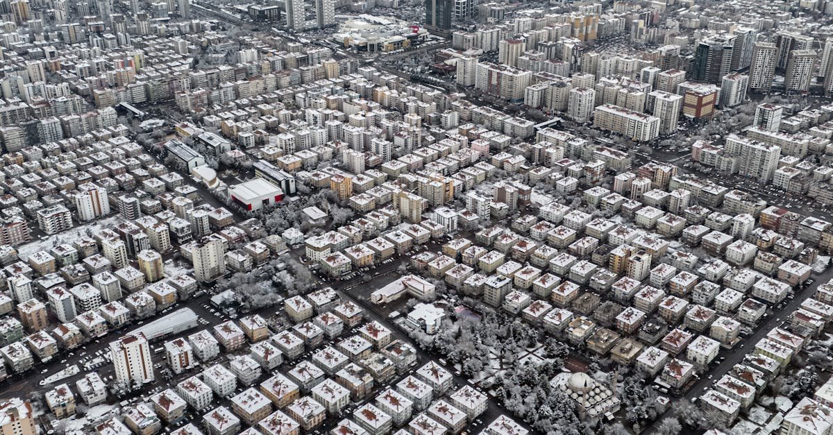 Aerial view of Kayseri showcasing a snow-covered urban landscape and mountainous horizon.