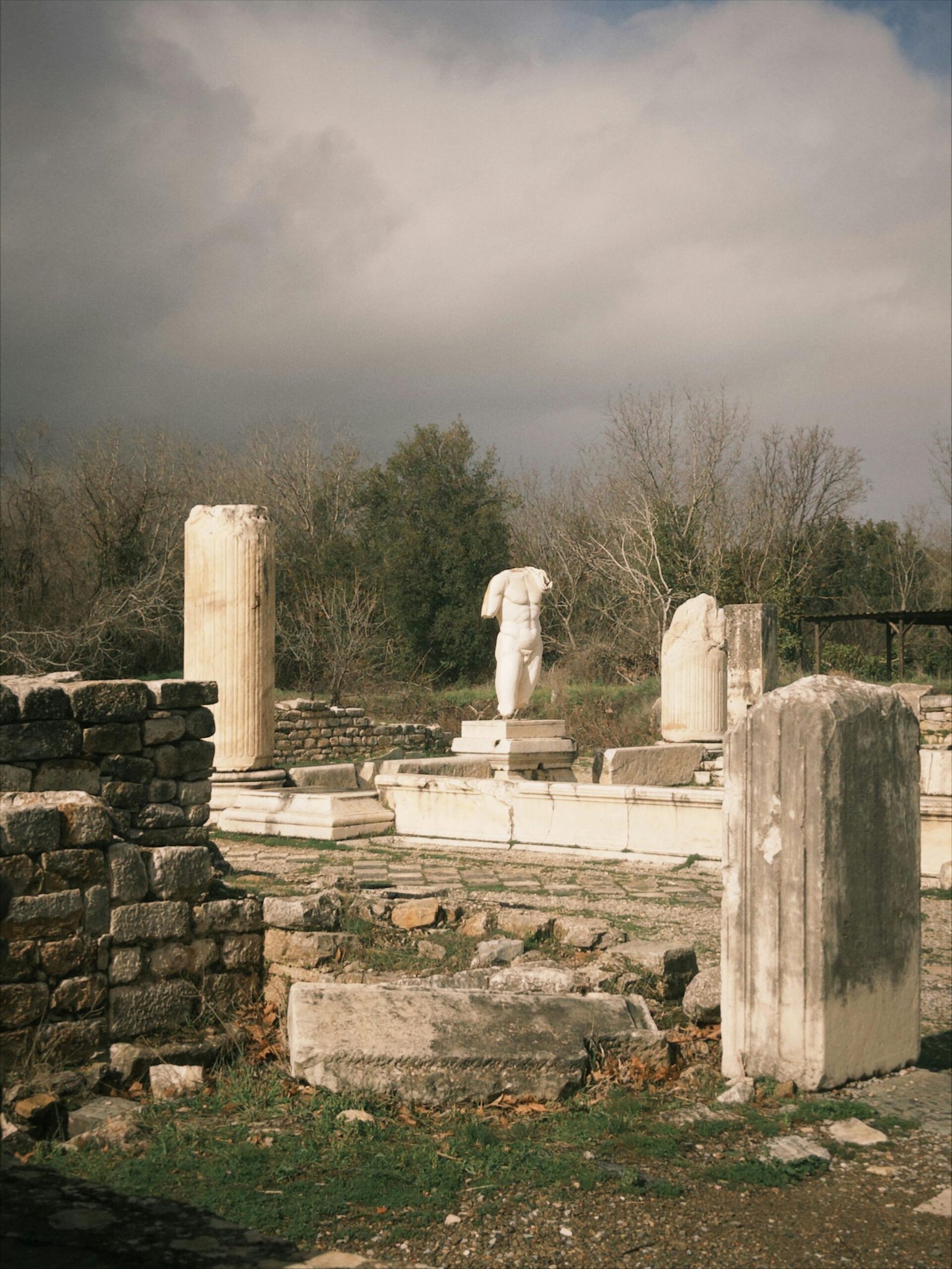 A captivating view of ancient ruins with columns in Aydın, Türkiye, under a dramatic sky.