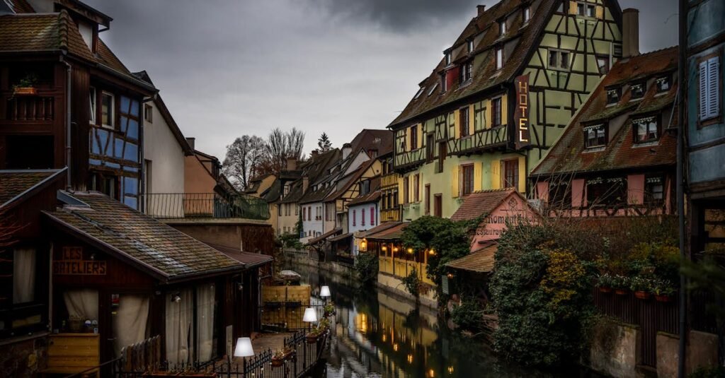 Picturesque canal scene in Colmar, France, showcasing charming medieval architecture and vibrant reflections.