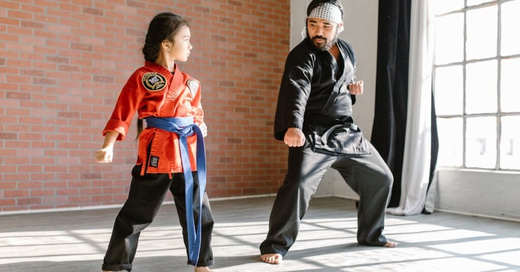 A child practicing martial arts with an adult instructor in a sunlit dojo.