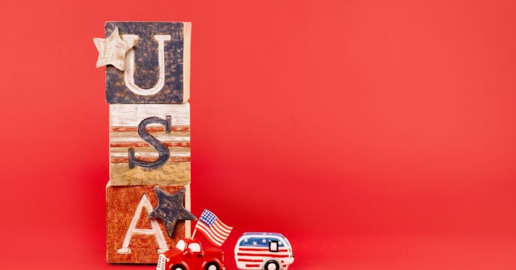 USA-themed wooden blocks and toy vehicles with flags on a red background.