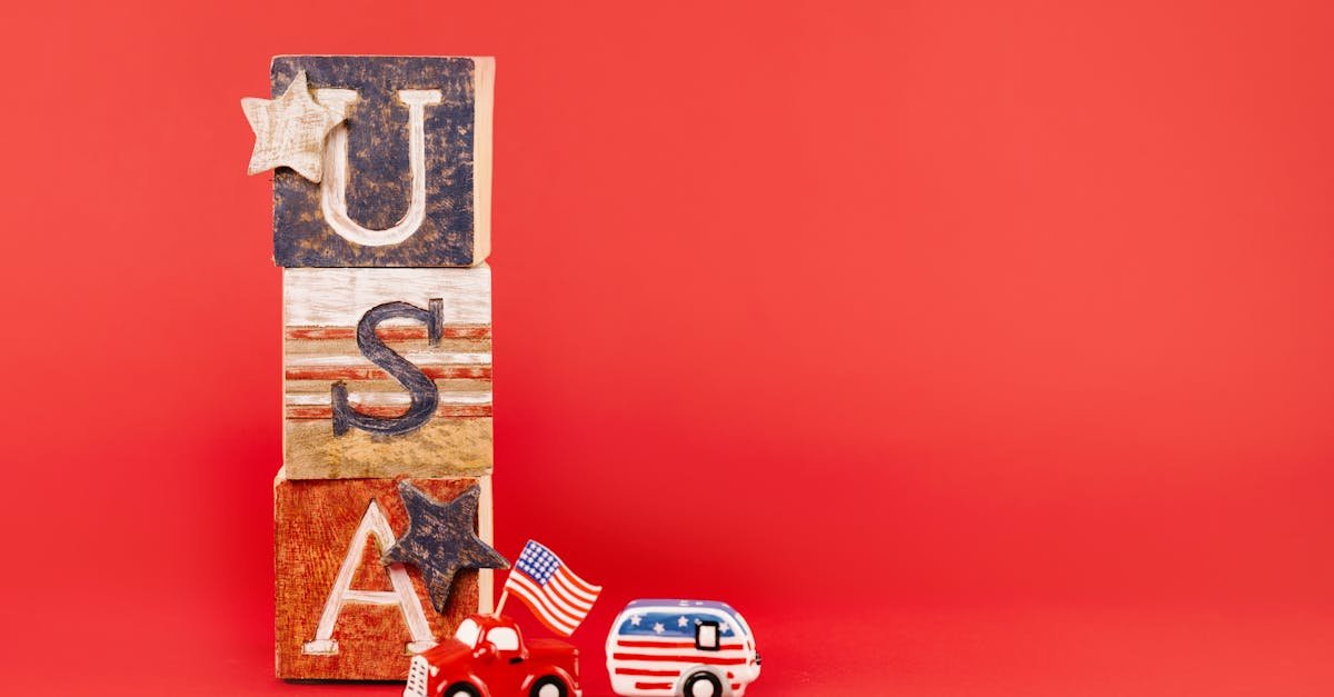 USA-themed wooden blocks and toy vehicles with flags on a red background.
