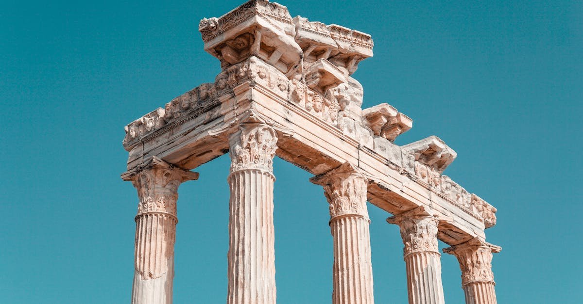 View of the historic columns of the Temple of Apollo under a clear blue sky in Antalya.