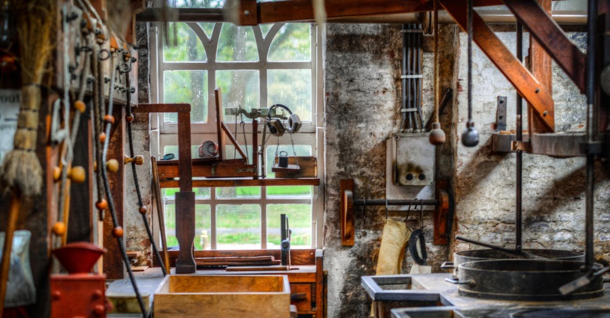 Explore the vintage charm of a rustic workshop interior filled with metalworking tools and wooden furniture.