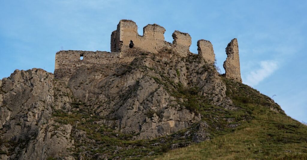 Explore the ancient Trascău Fortress ruins perched atop a rocky hill in Romania's scenic landscape.