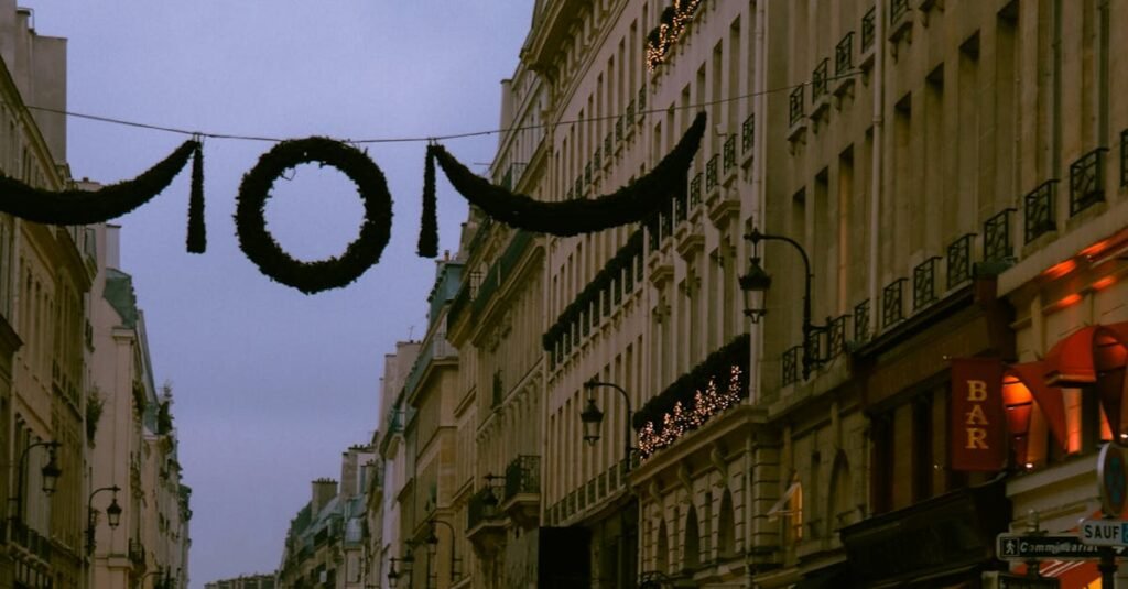 A bustling street scene in Paris at dusk, showcasing historic architecture and city life.