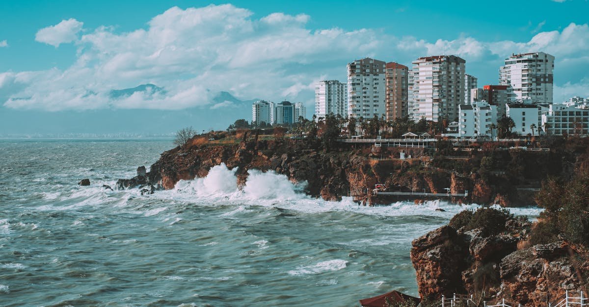 Scenic view of Antalya's beautiful coastline and modern architecture under a vibrant sky.