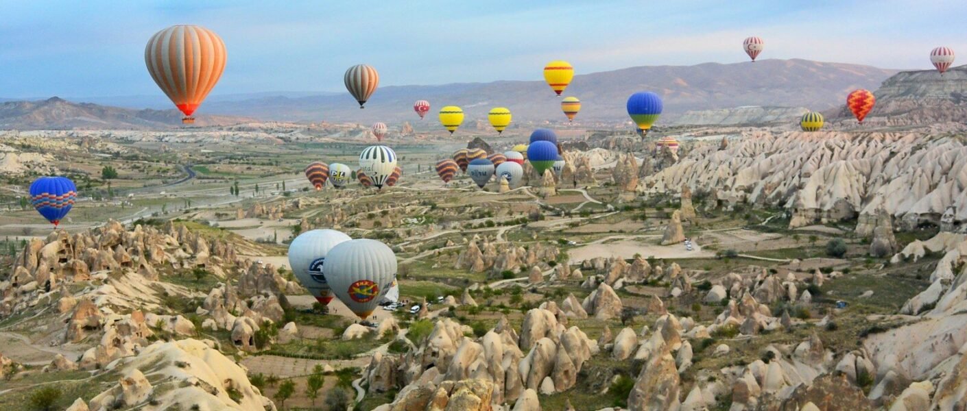 photo of assorted-color air balloon lot in mid air during daytime