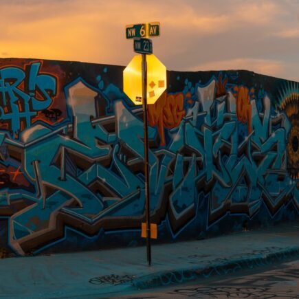 Graffiti wall and street sign at sunset