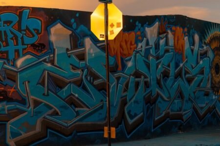 Graffiti wall and street sign at sunset