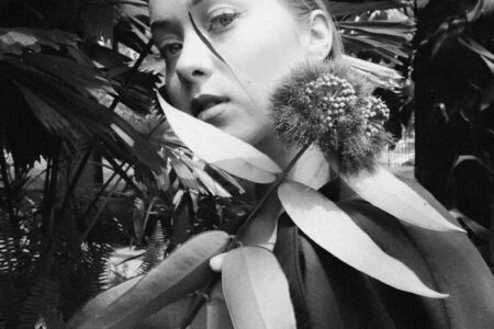 Young woman with plant leaves around her neck