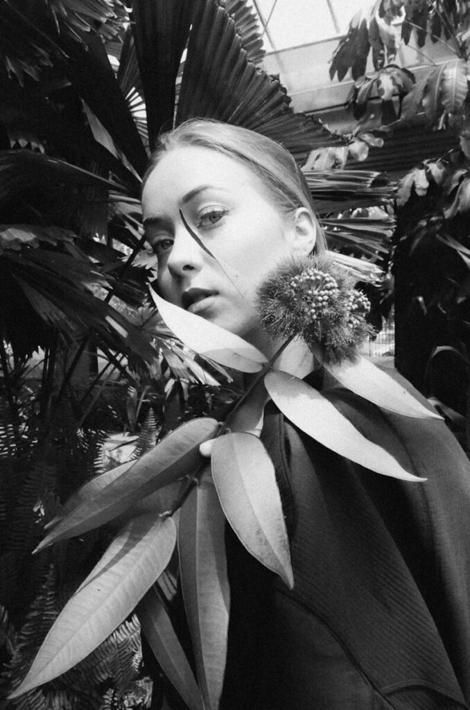 Young woman with plant leaves around her neck