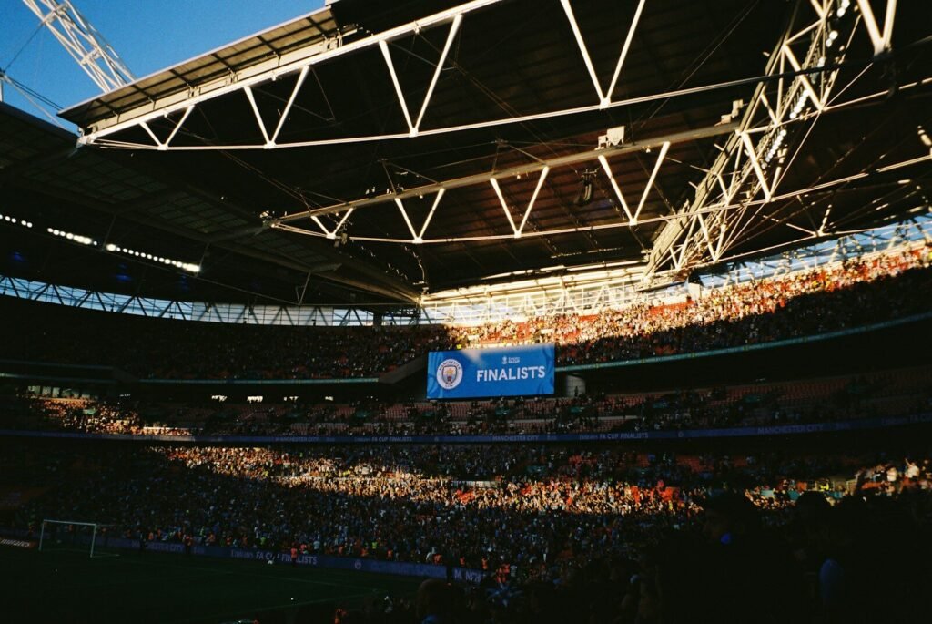 Stadium filled with spectators during a sunny day event.