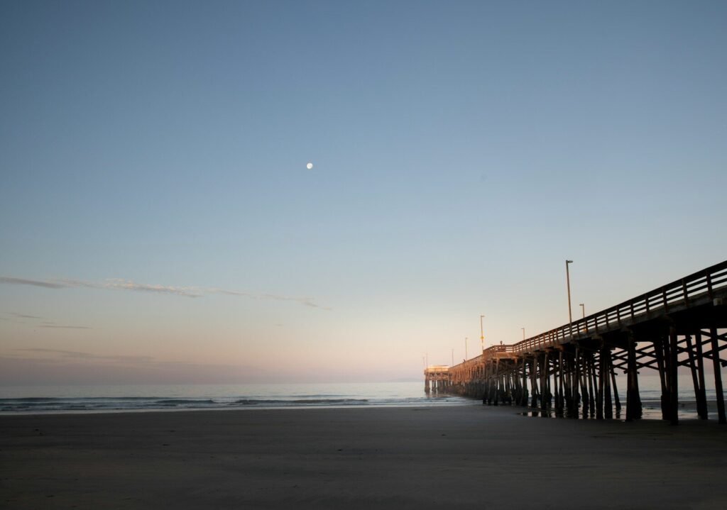 A long pier stretches out into the ocean