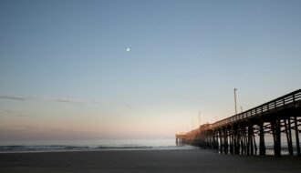 A long pier stretches out into the ocean