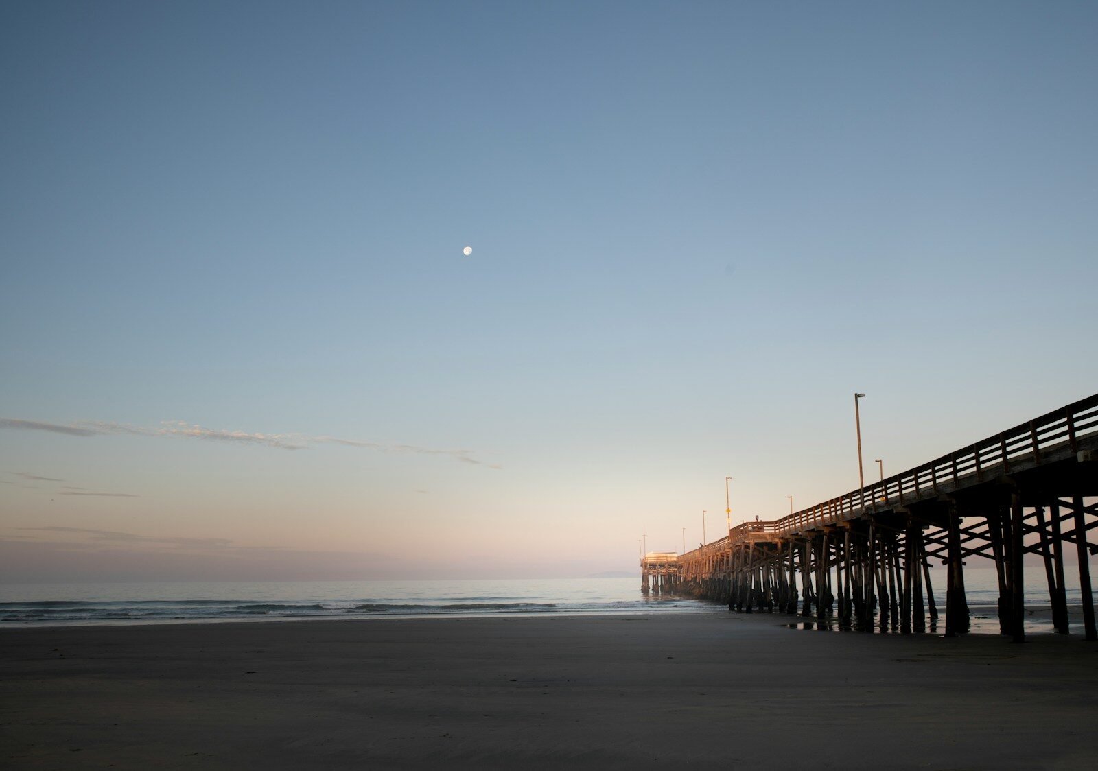 A long pier stretches out into the ocean