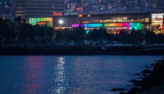 A captivating view of Samsun's illuminated skyline at night, reflecting over the waterfront with urban vibrance.