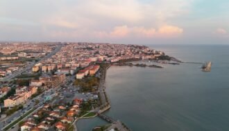 Captivating aerial view of Silivri, İstanbul during sunrise showcasing the coast and urban landscape.