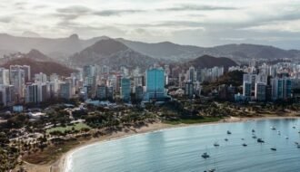 Stunning aerial view of Vitória's coastline, showcasing modern architecture and natural beauty.