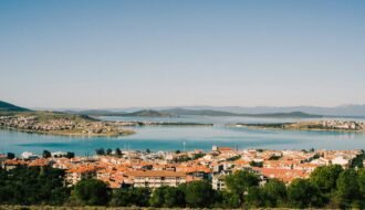 a view of a city and a lake from a hill