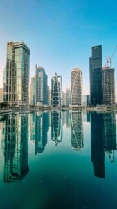 Stunning view of Dubai's modern skyscrapers reflecting perfectly in a serene city lake.